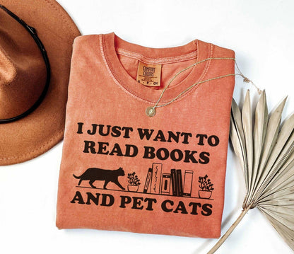 A comfort colors shirt with the saying "I just want to read books and pet cats"