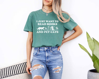 A comfort colors shirt with the saying "I just want to read books and pet cats"