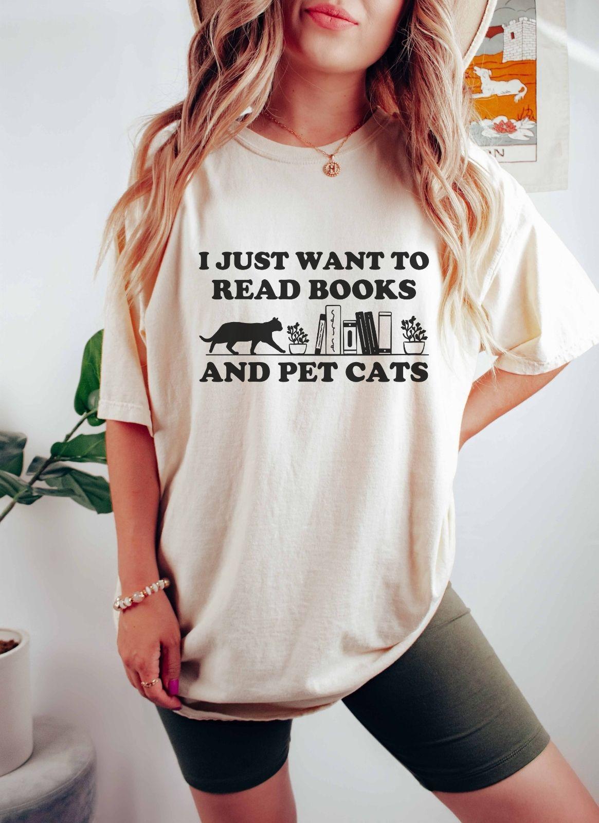 A comfort colors shirt with the saying "I just want to read books and pet cats"