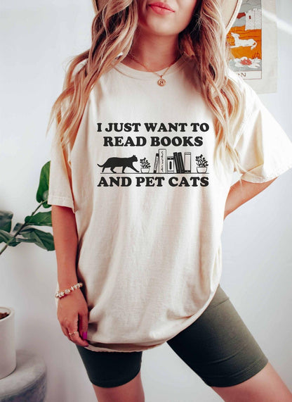 A comfort colors shirt with the saying "I just want to read books and pet cats"