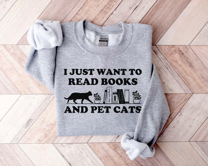 A comfort colors shirt with the saying "I just want to read books and pet cats"