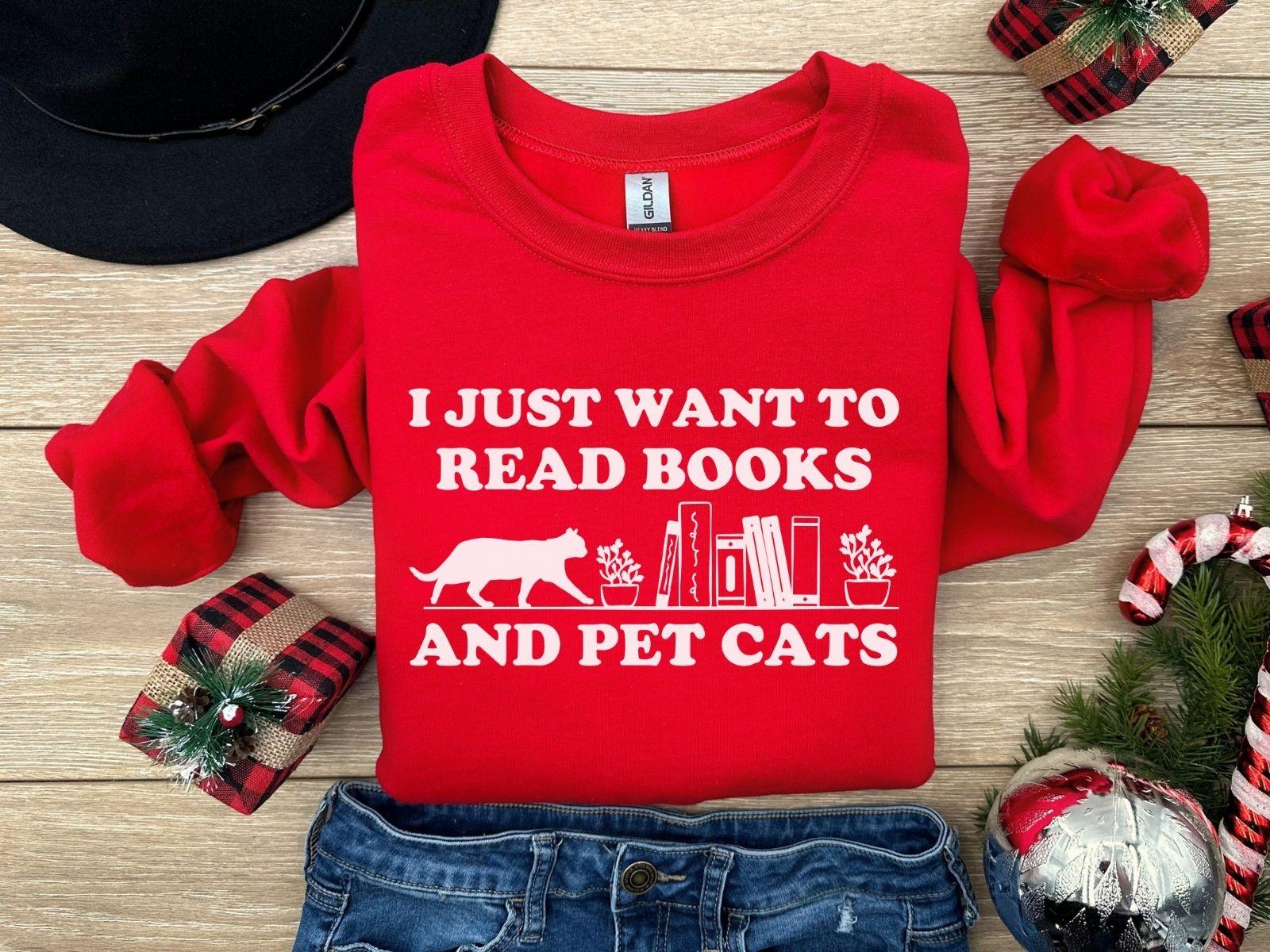 A comfort colors shirt with the saying "I just want to read books and pet cats"