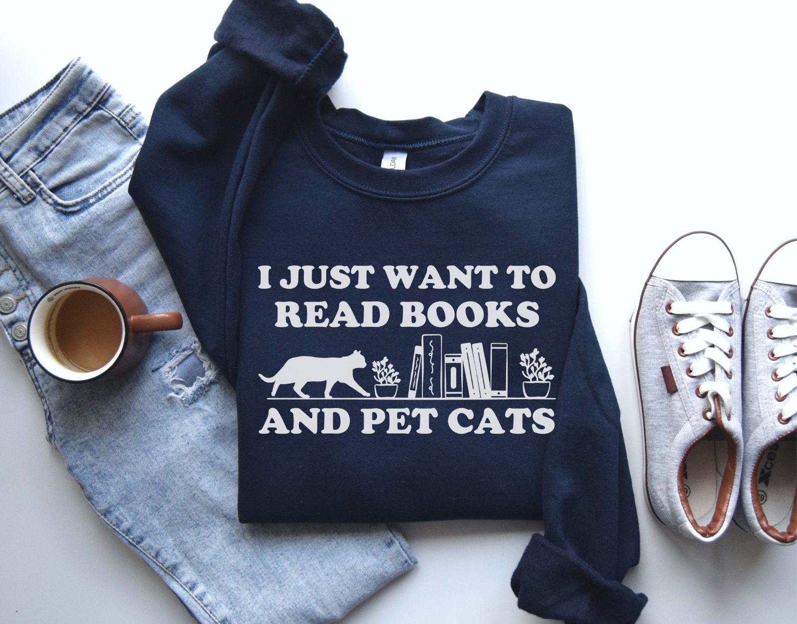 A comfort colors shirt with the saying "I just want to read books and pet cats"