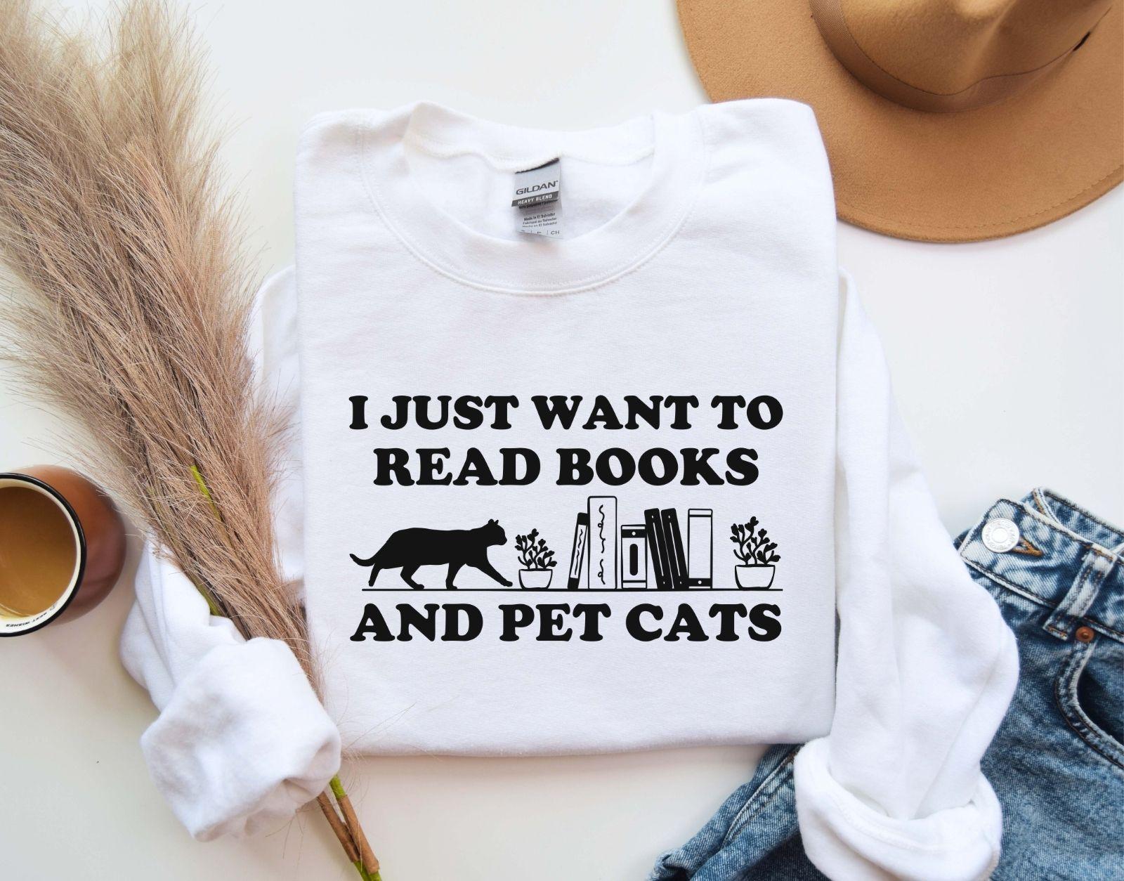 A comfort colors shirt with the saying "I just want to read books and pet cats"