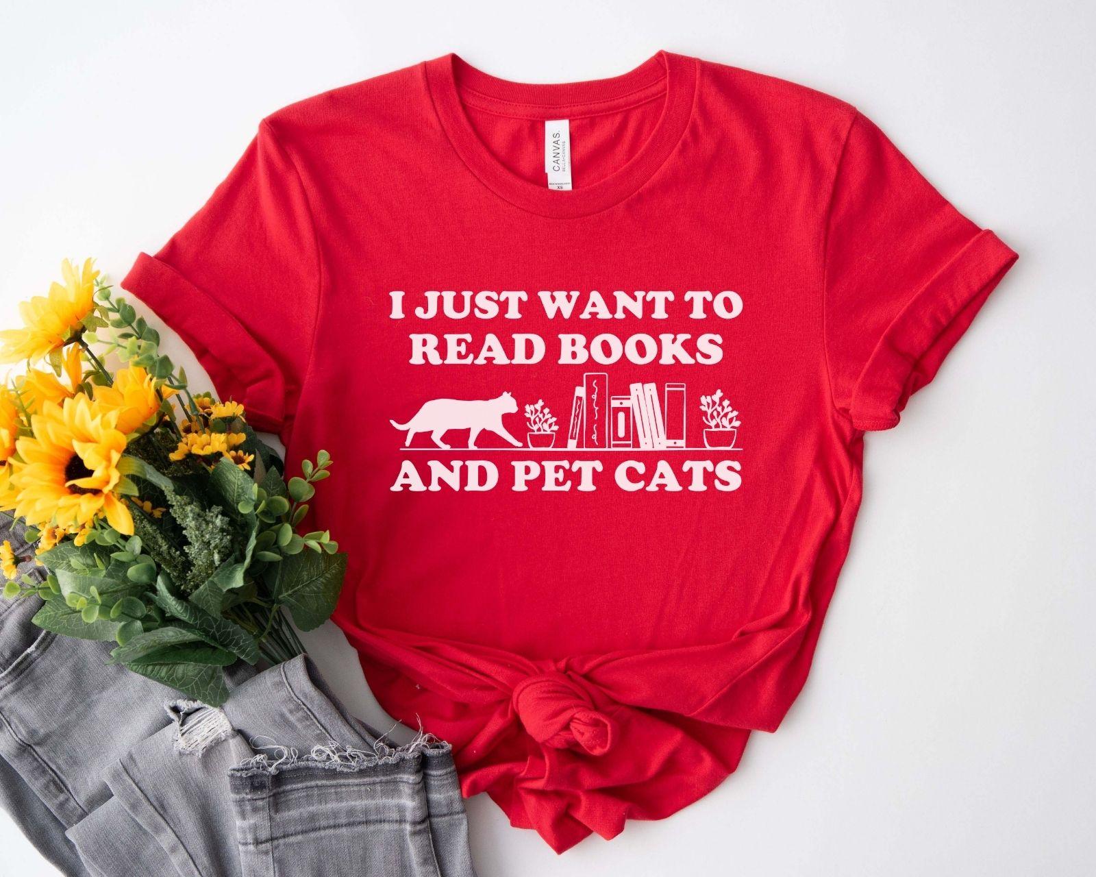 A comfort colors shirt with the saying "I just want to read books and pet cats"