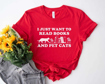 A comfort colors shirt with the saying "I just want to read books and pet cats"