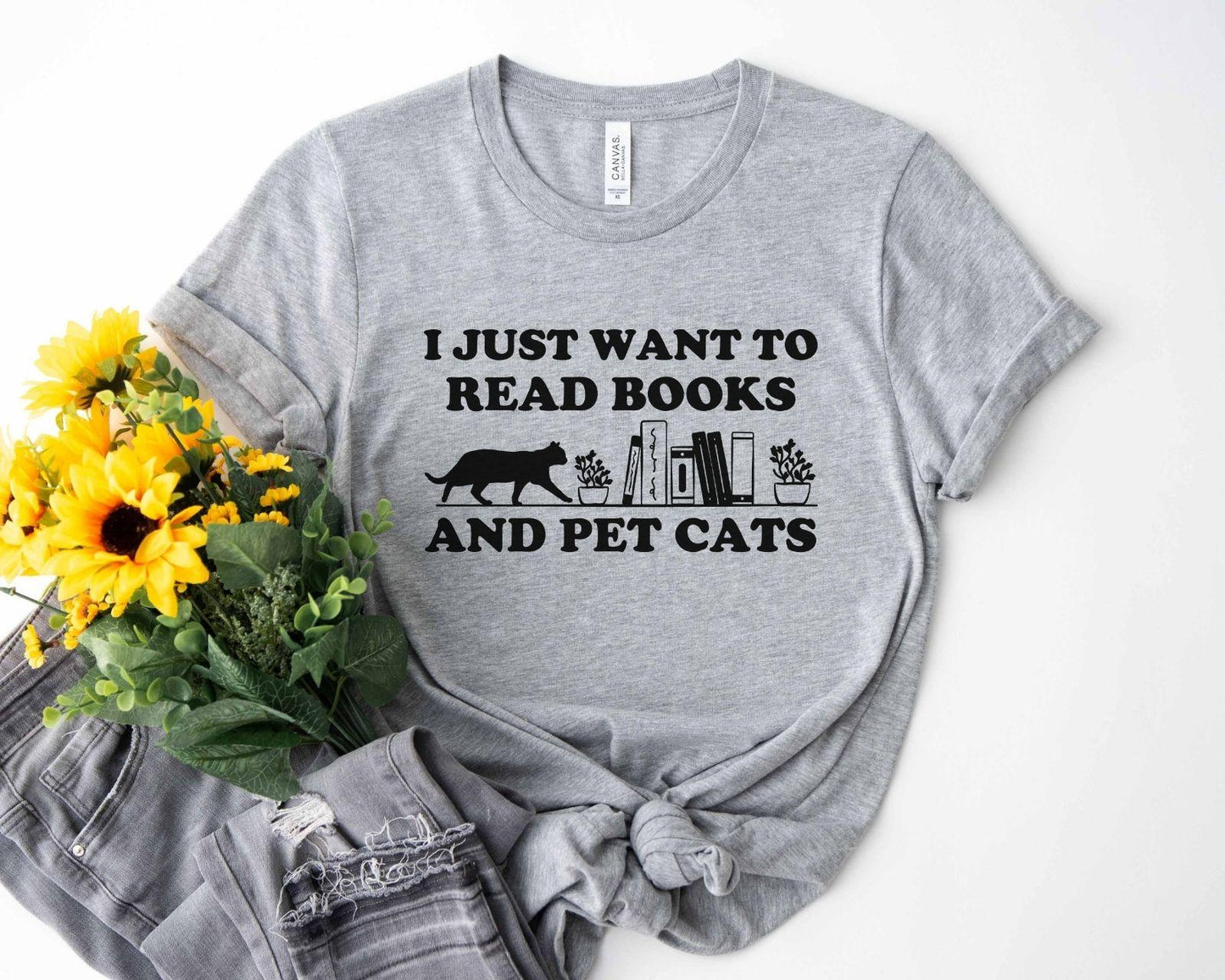 A comfort colors shirt with the saying "I just want to read books and pet cats"