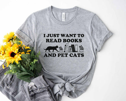 A comfort colors shirt with the saying "I just want to read books and pet cats"
