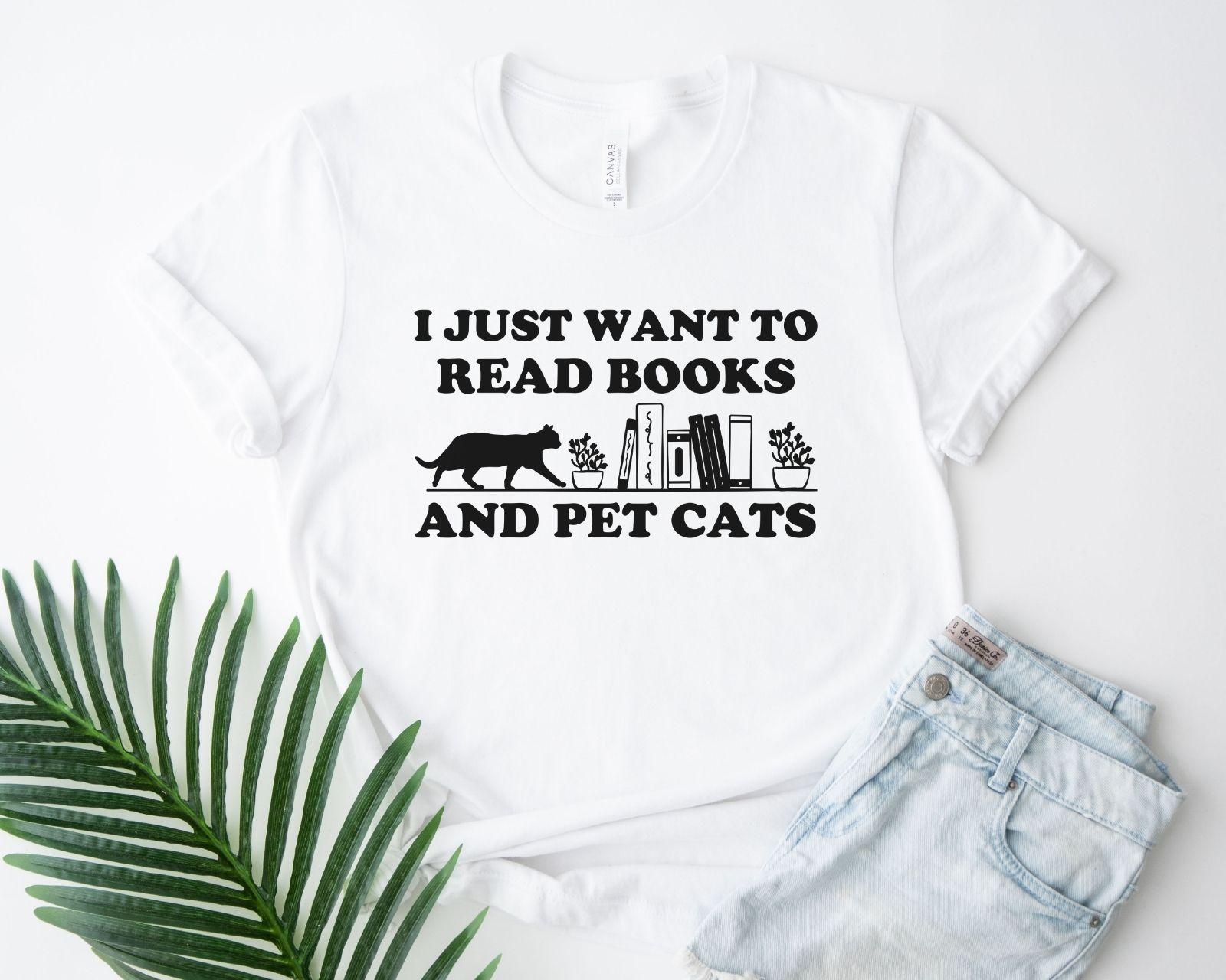 A comfort colors shirt with the saying "I just want to read books and pet cats"