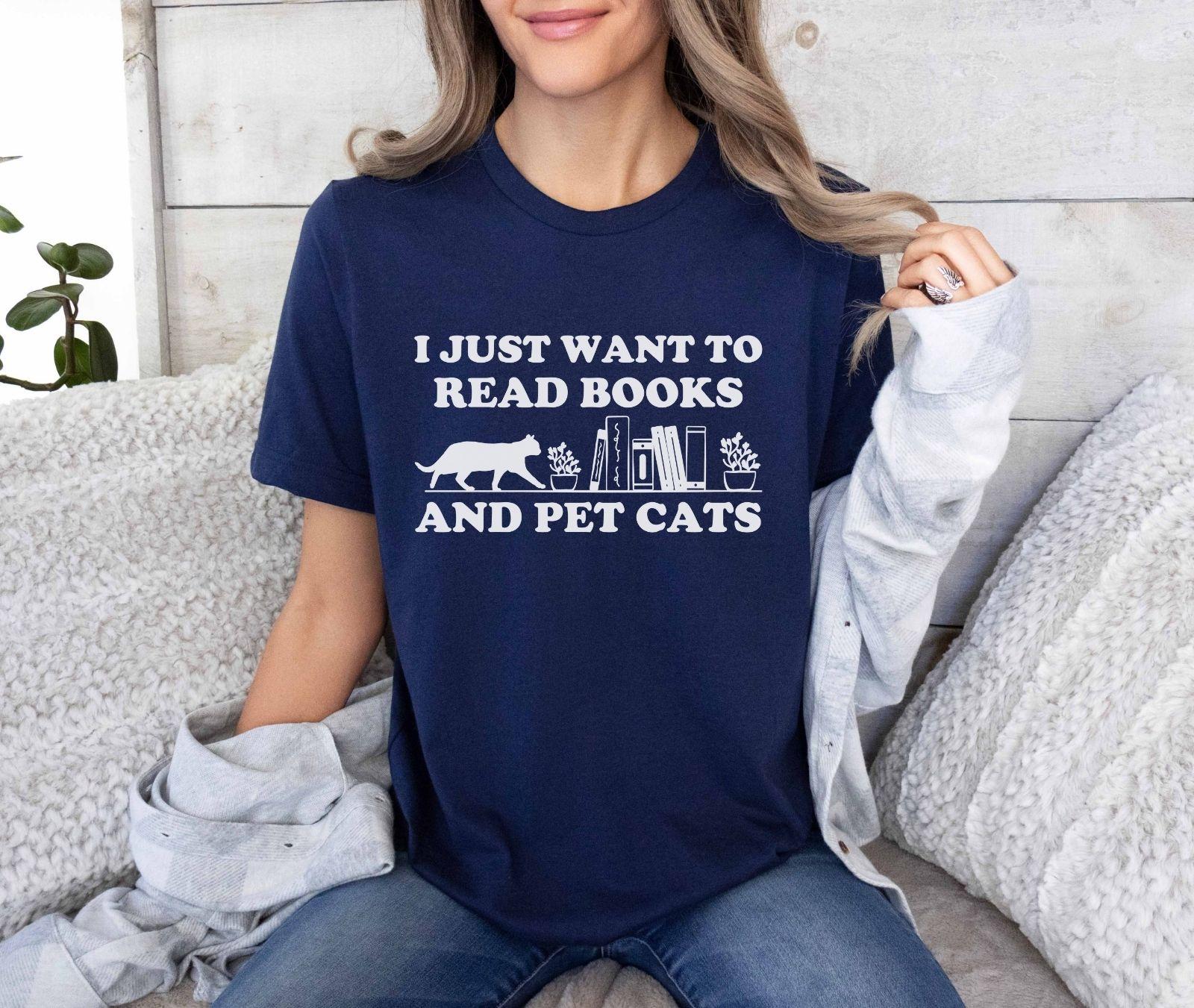A comfort colors shirt with the saying "I just want to read books and pet cats"