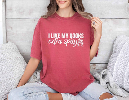A comfort colors shirt with the saying "I like my books extra spicy"