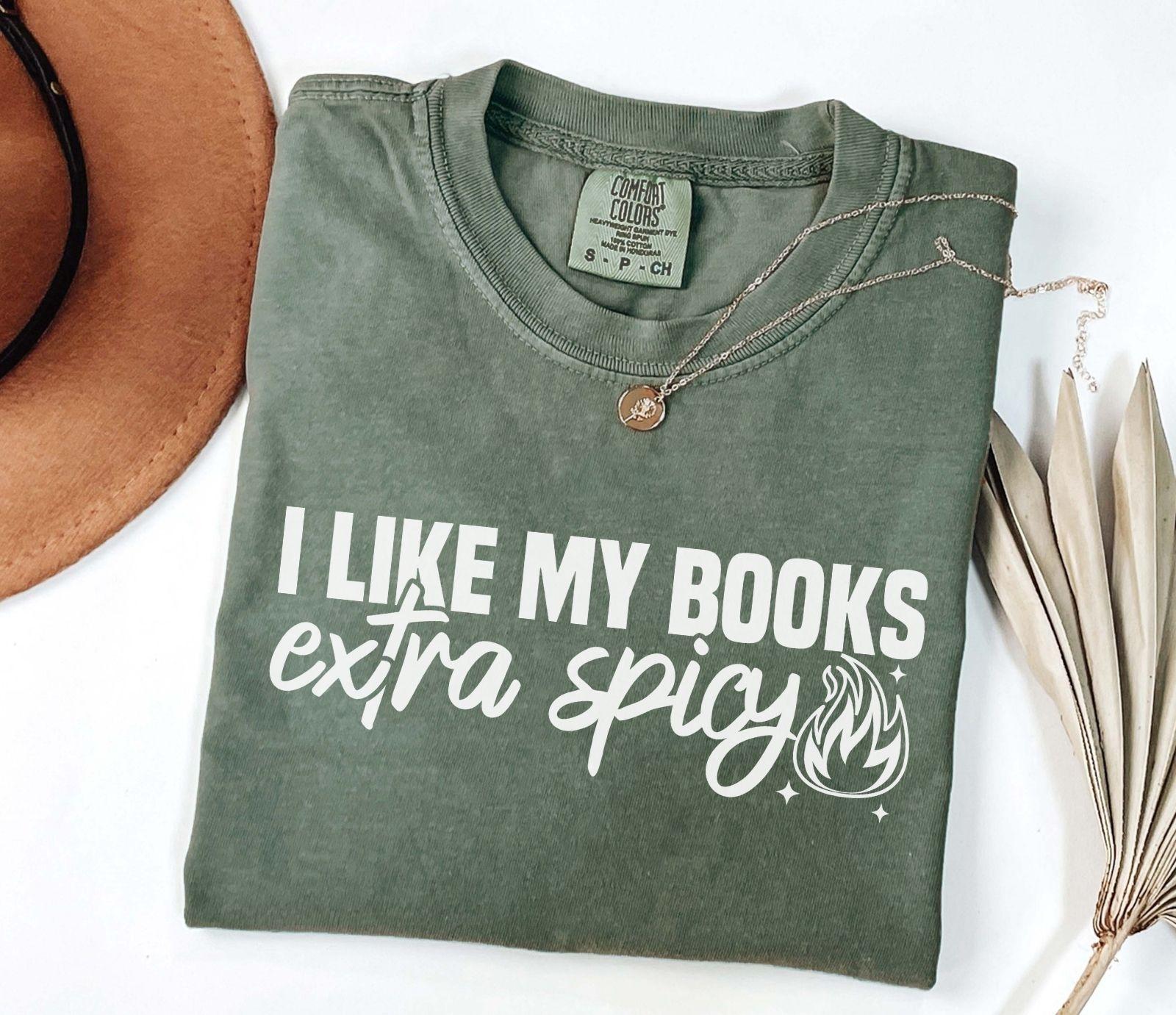 A comfort colors shirt with the saying "I like my books extra spicy"