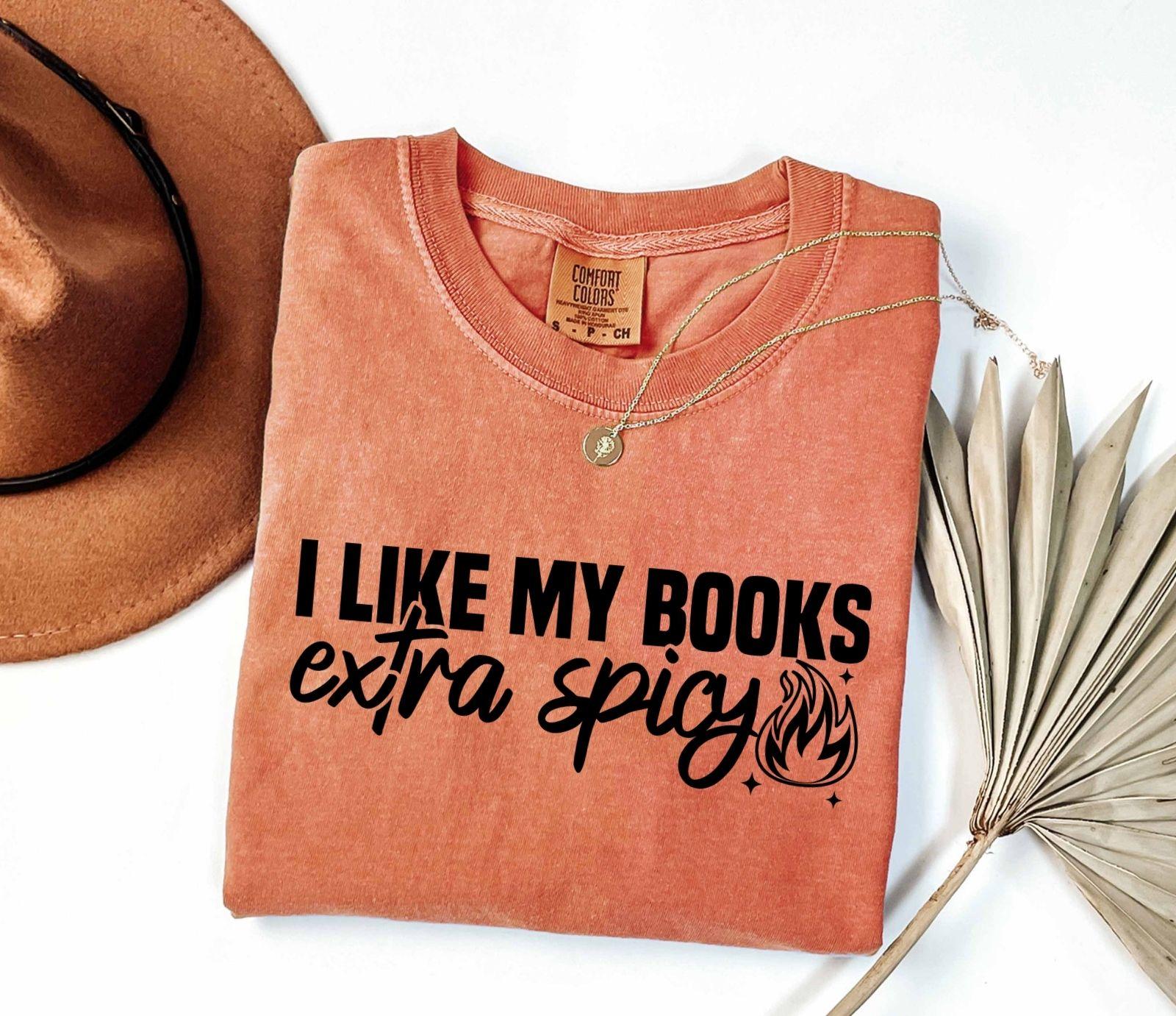 A comfort colors shirt with the saying "I like my books extra spicy"