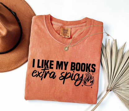 A comfort colors shirt with the saying "I like my books extra spicy"