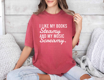 A comfort colors shirt with the saying "I like my books steamy and my music screamy"