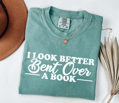 A comfort colors® shirt with the saying "I look better bent over a book"