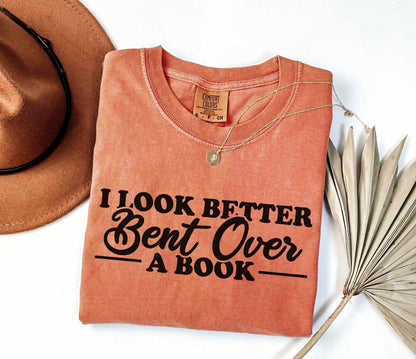 A comfort colors® shirt with the saying "I look better bent over a book"