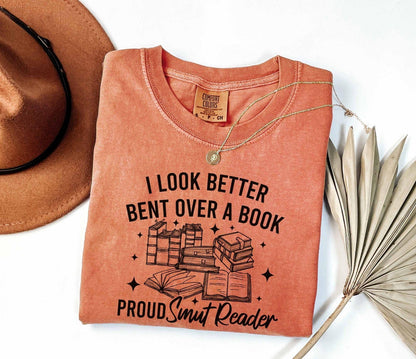 A comfort colors shirt with the saying "I look better bent over a book proud smut reader"