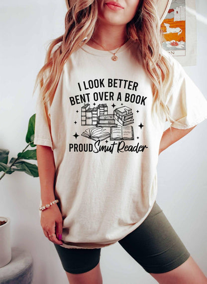 A comfort colors shirt with the saying "I look better bent over a book proud smut reader"