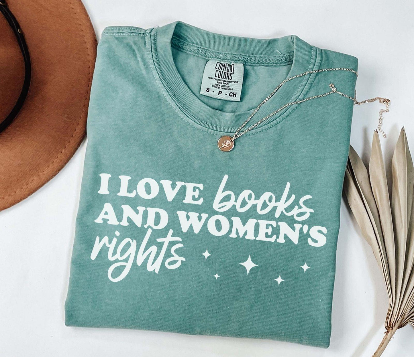 A comfort colors shirt with the saying "I love books and women's rights"