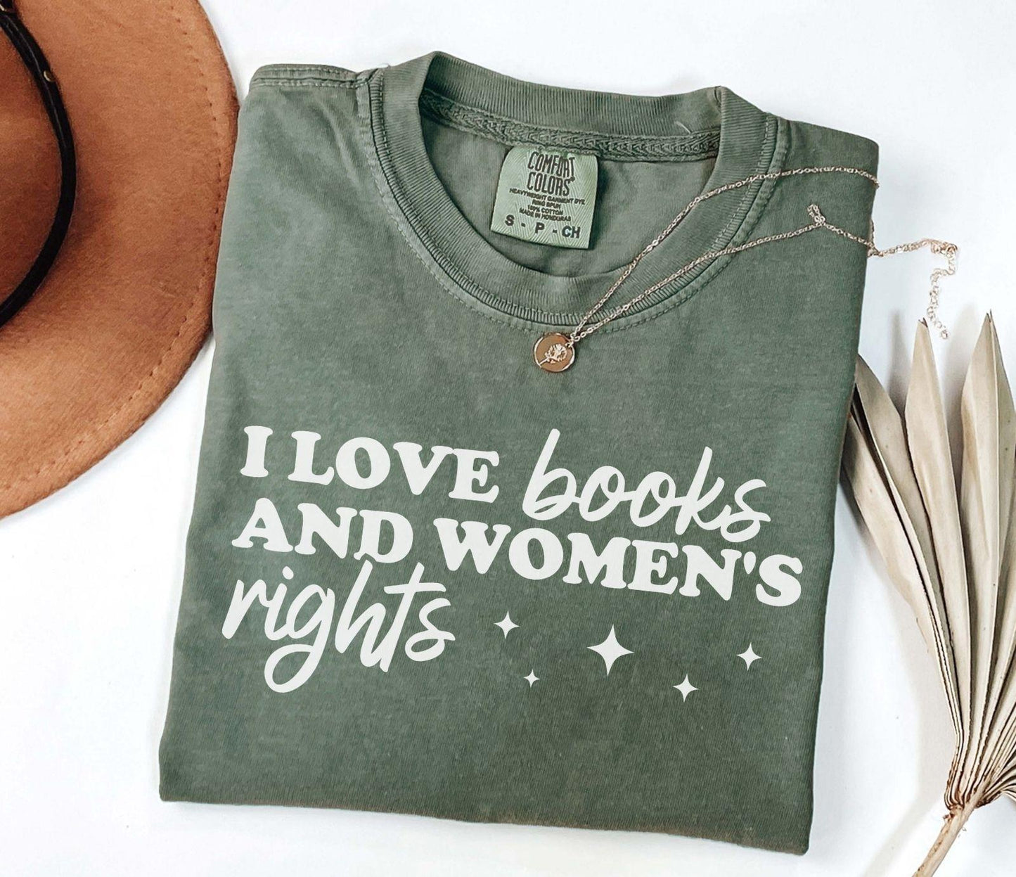 A comfort colors shirt with the saying "I love books and women's rights"