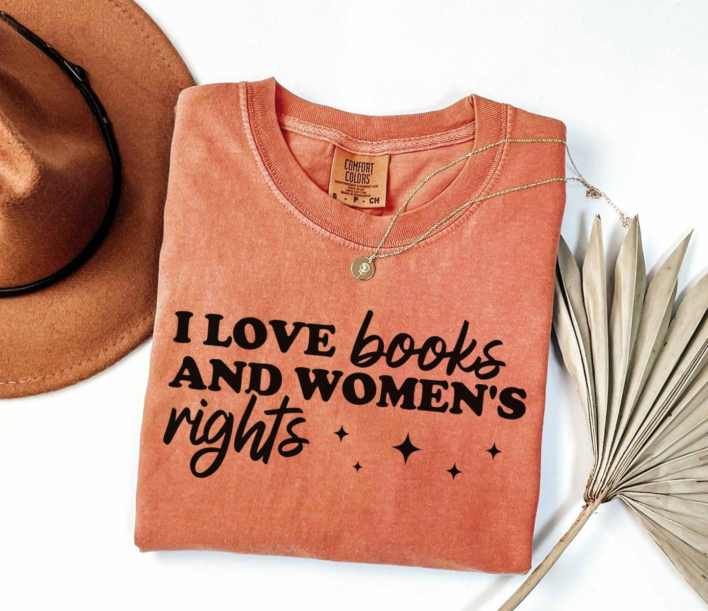 A comfort colors shirt with the saying "I love books and women's rights"