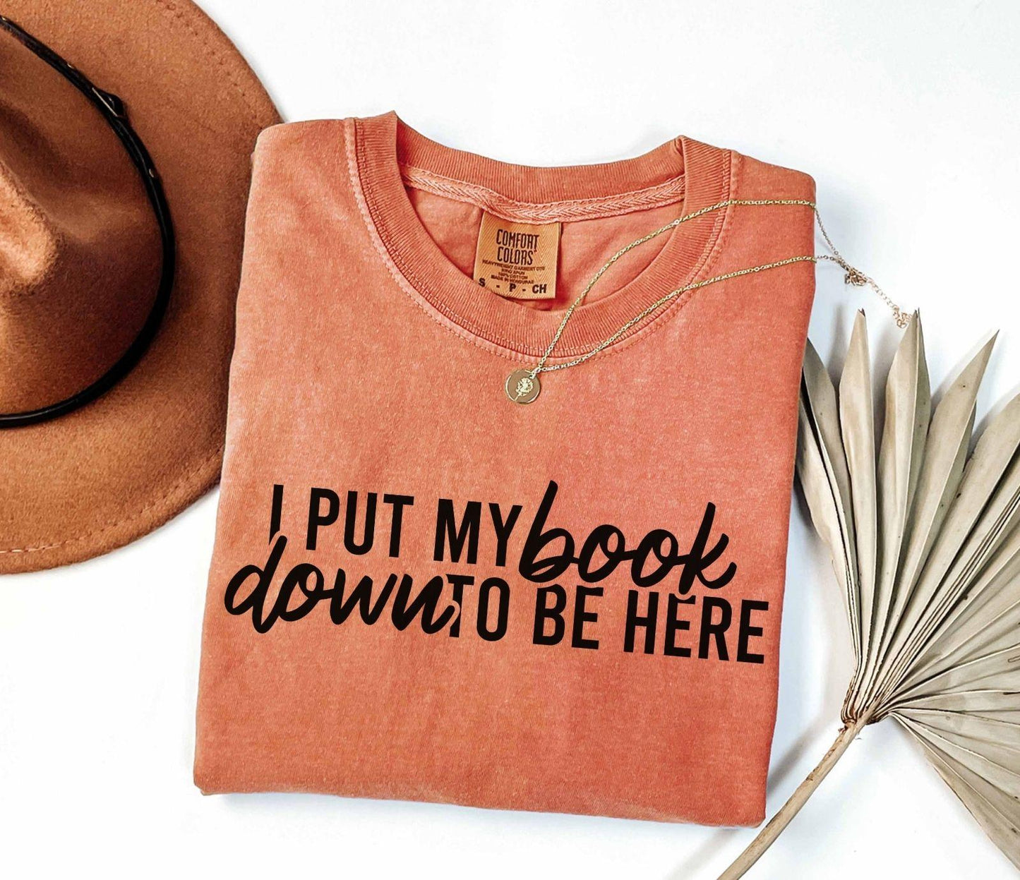 A comfort colors® shirt with the saying "I put my book down to be here"
