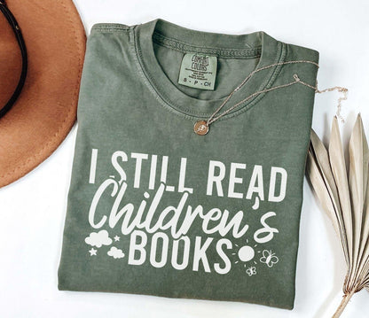 A comfort colors® shirt with the saying "I still read children's books"