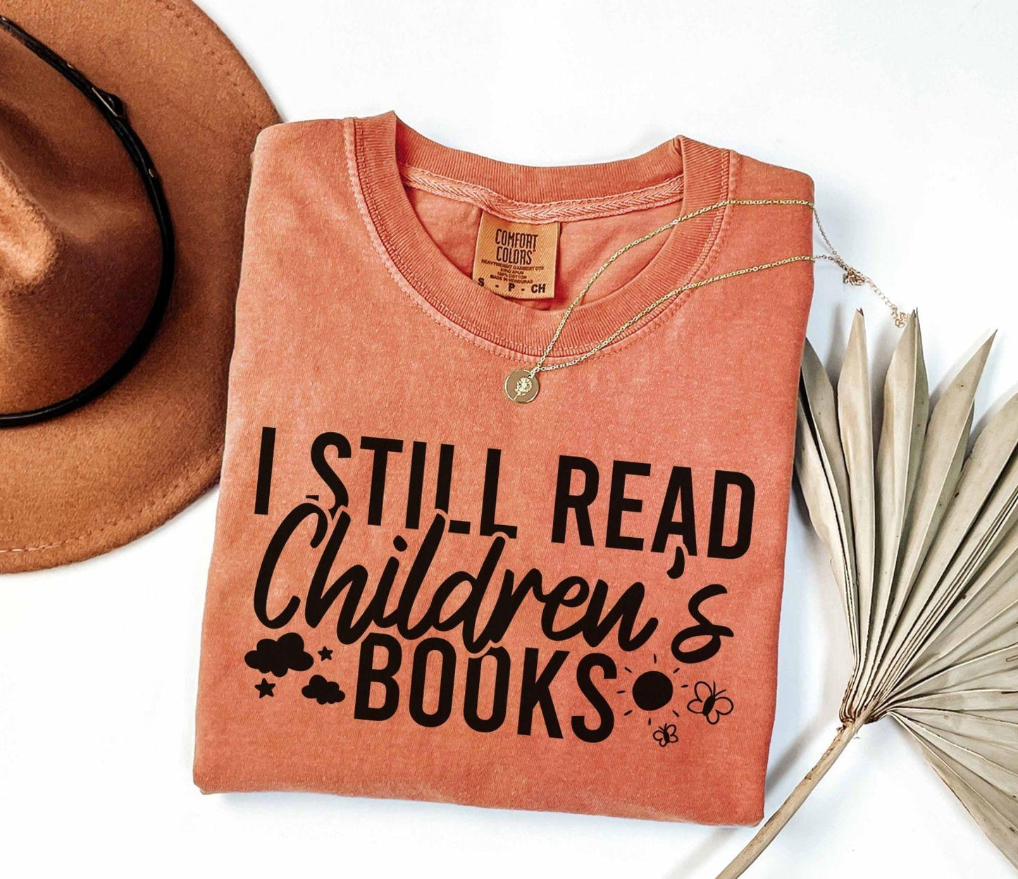 A comfort colors® shirt with the saying "I still read children's books"