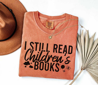A comfort colors® shirt with the saying "I still read children's books"