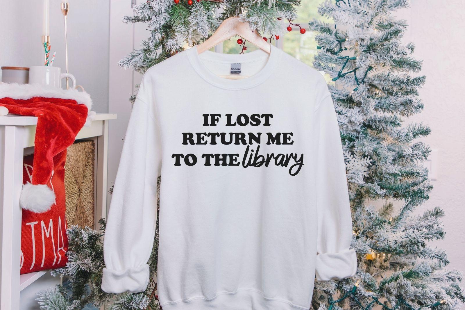 A Gildan 18000 sweatshirt with the saying "if lost return me to the library"