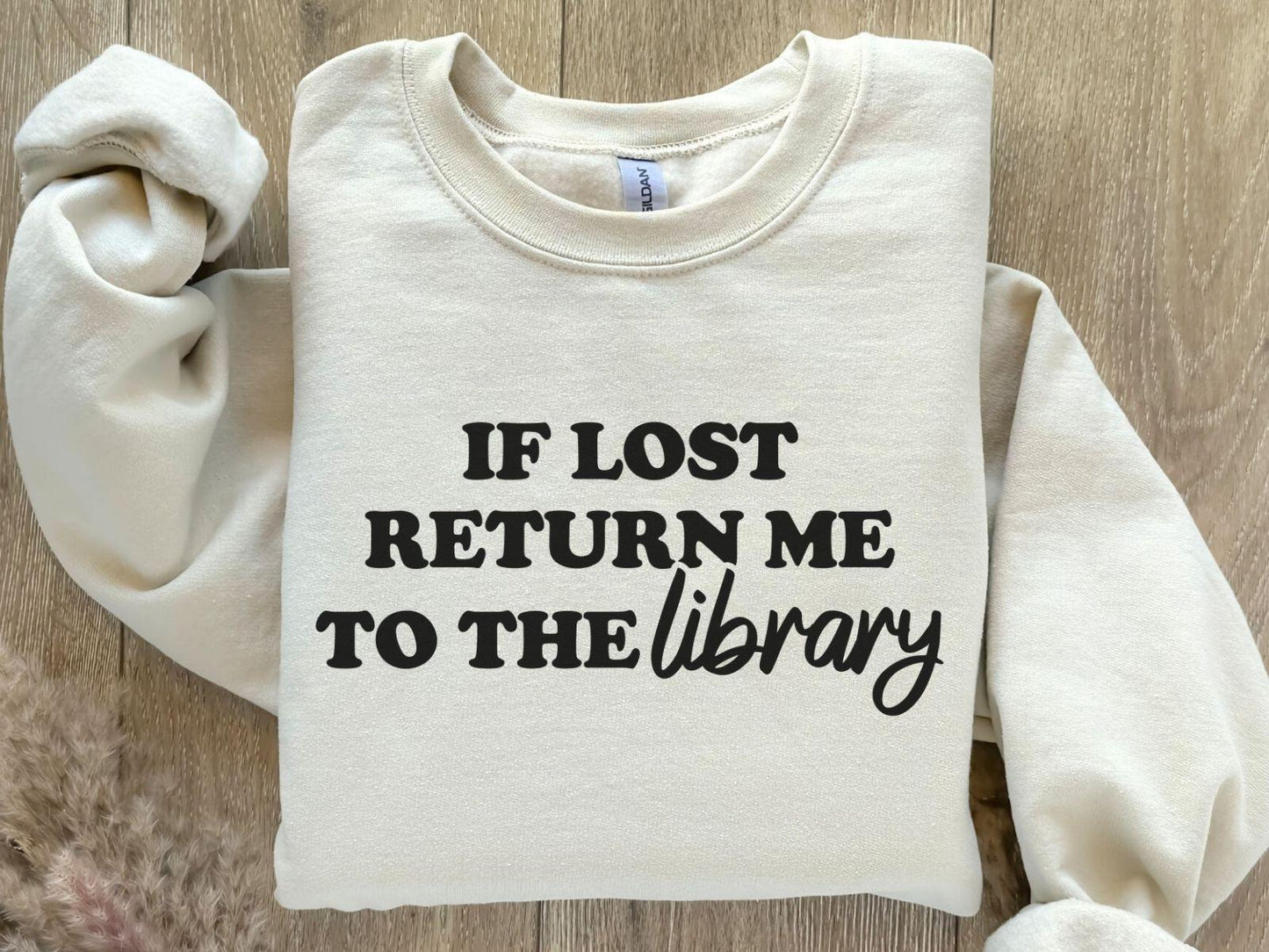 A Gildan 18000 sweatshirt with the saying "if lost return me to the library"
