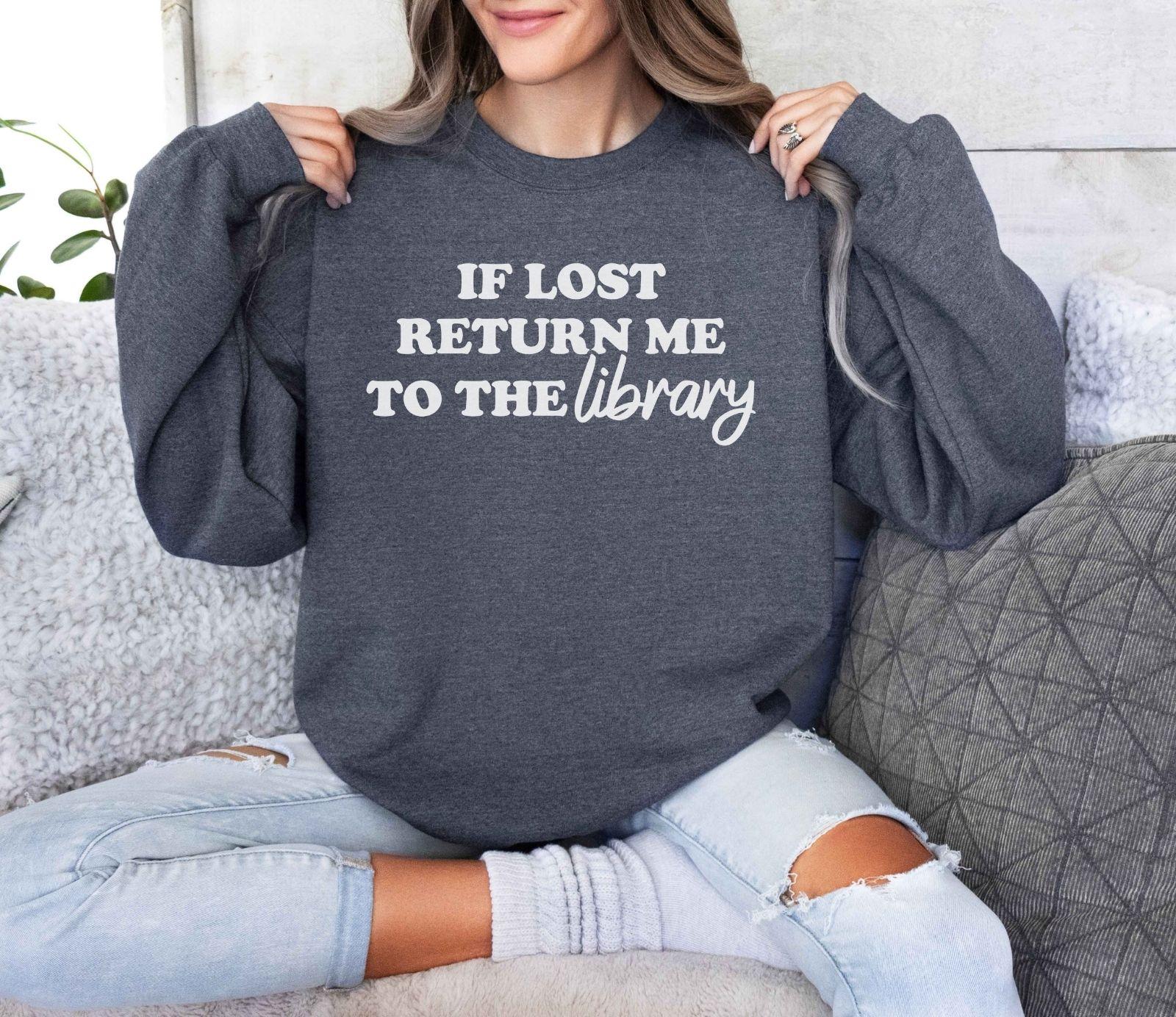 A Gildan 18000 sweatshirt with the saying "if lost return me to the library"