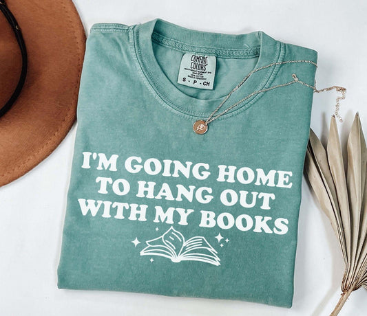 A comfort colors shirt with the saying "I'm going home to hang out with my books"