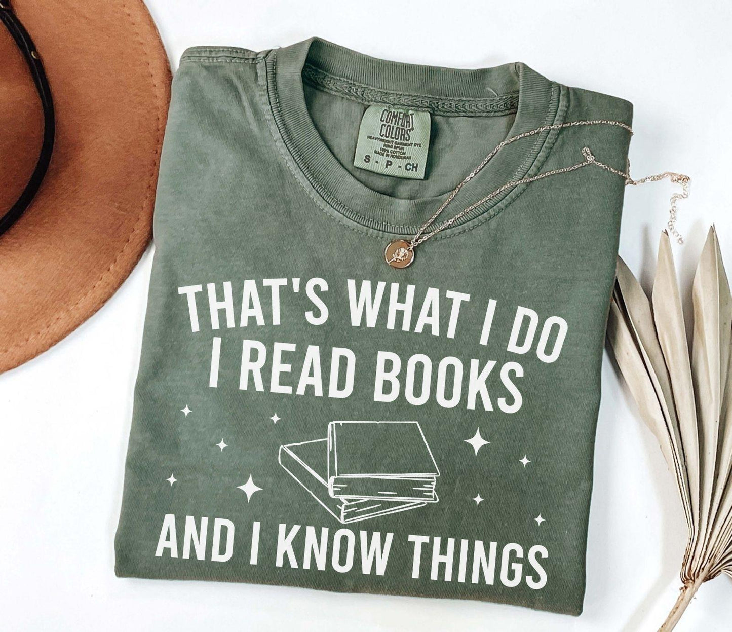 A comfort colors® shirt with the saying "That's what I do I read books and I know things"