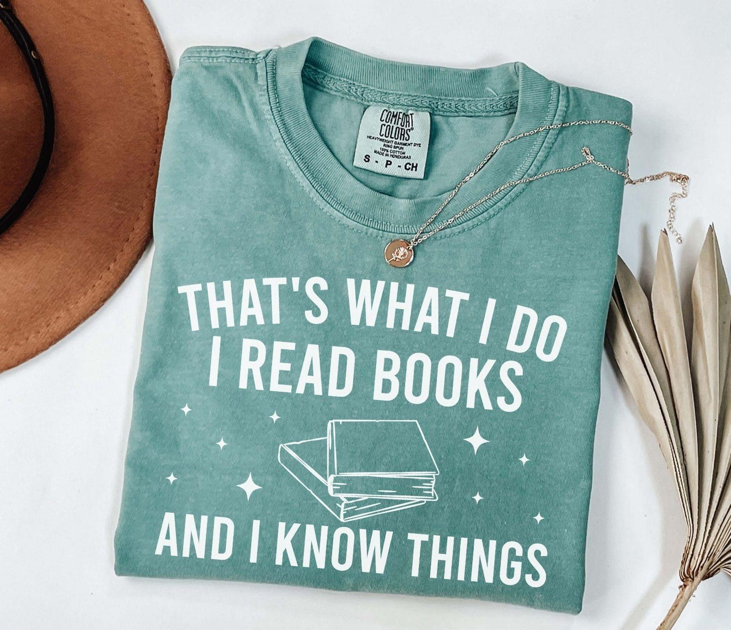 A comfort colors® shirt with the saying "That's what I do I read books and I know things"