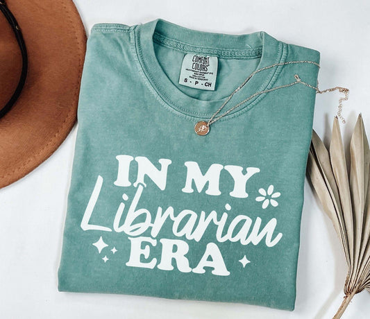 A comfort colors® shirt with the saying "In my librarian era"