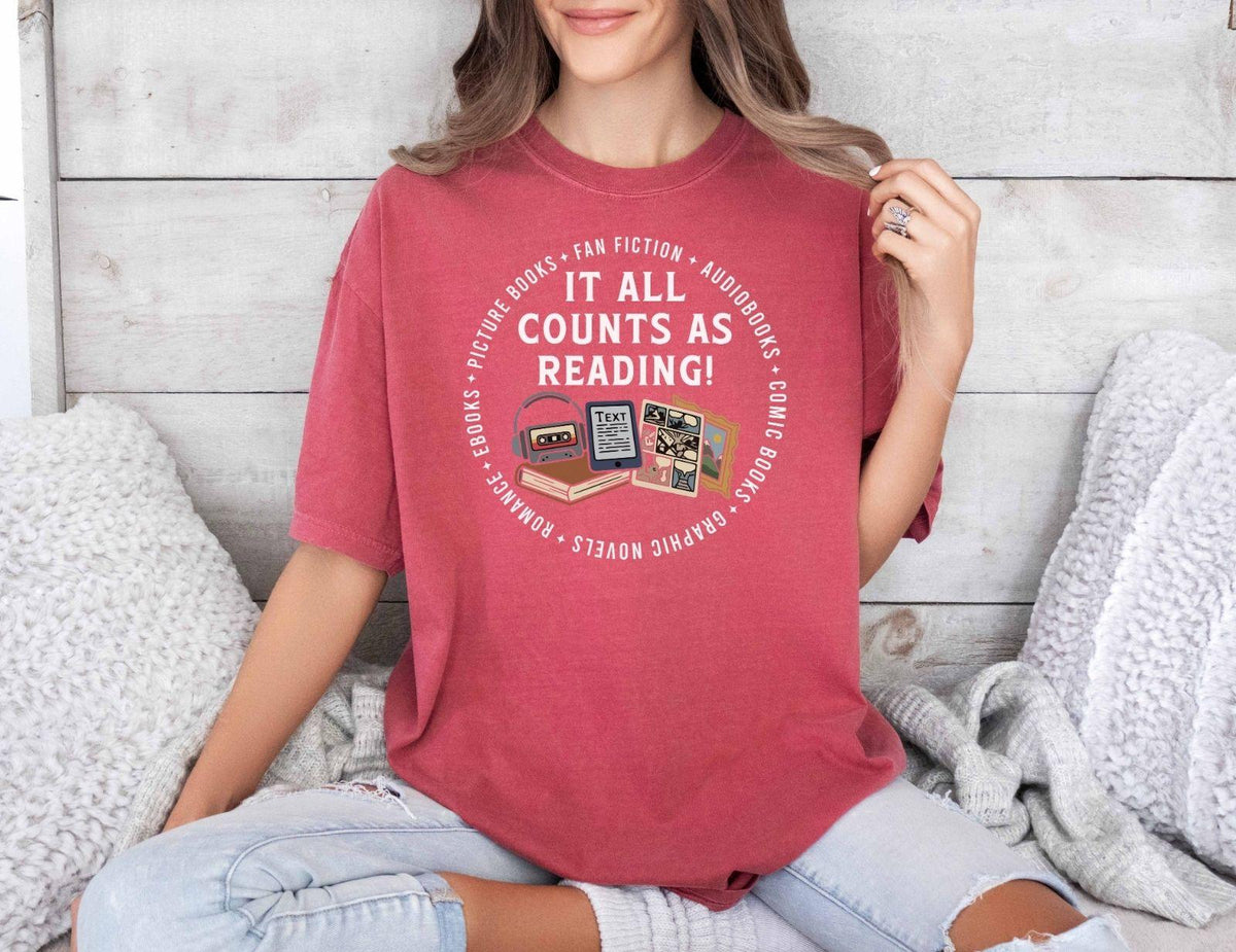 A comfort colors® shirt with the saying "it all counts as reading"