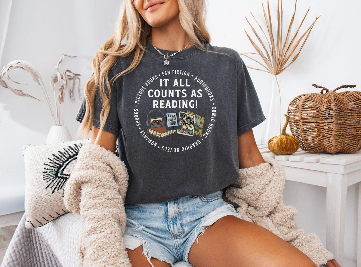 A comfort colors® shirt with the saying "it all counts as reading"