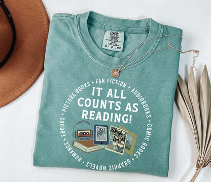 A comfort colors® shirt with the saying "it all counts as reading"
