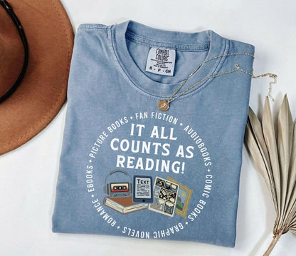 A comfort colors® shirt with the saying "it all counts as reading"