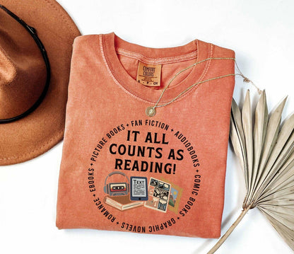 A comfort colors® shirt with the saying "it all counts as reading"