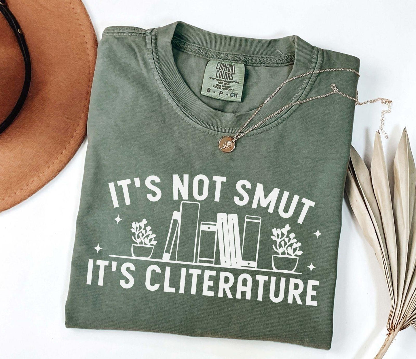A comfort colors shirt with the saying "It's not smut it's cliterature"