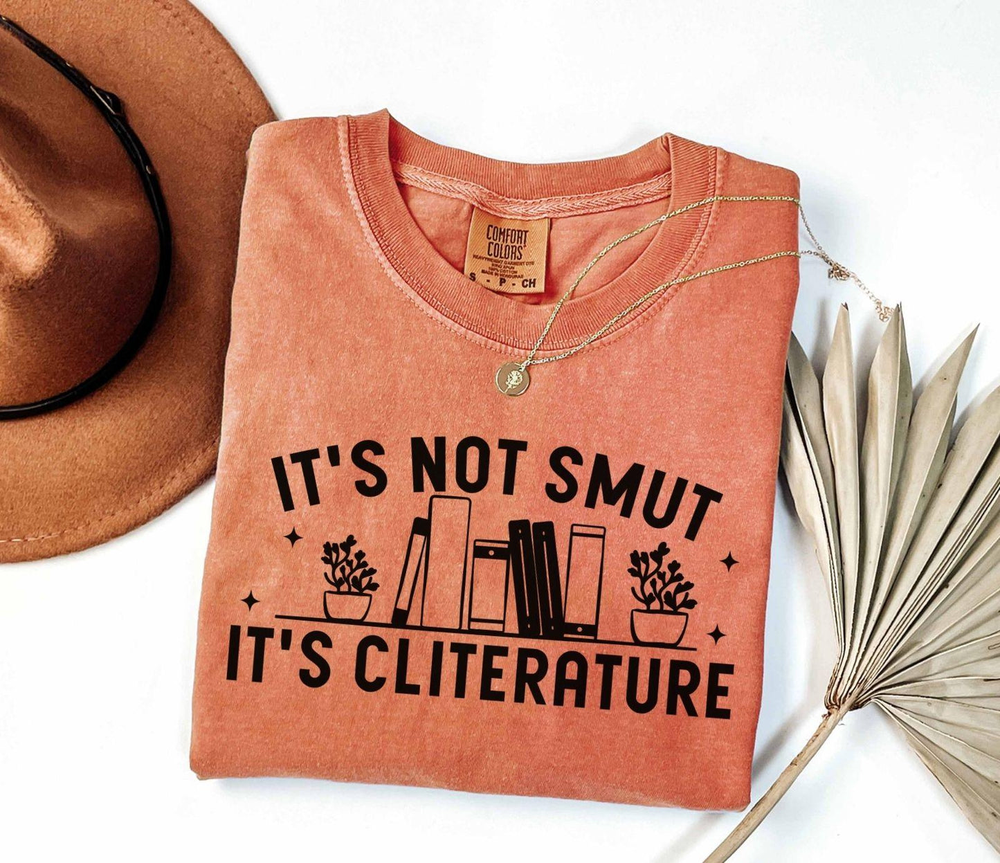 A comfort colors shirt with the saying "It's not smut it's cliterature"