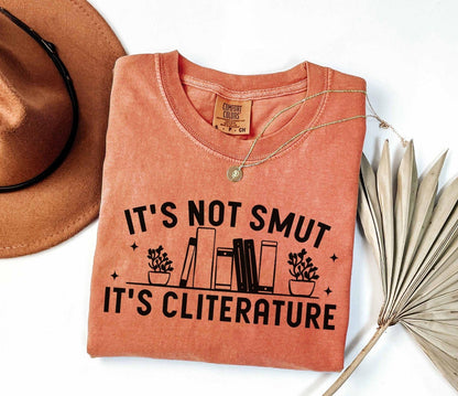 A comfort colors shirt with the saying "It's not smut it's cliterature"