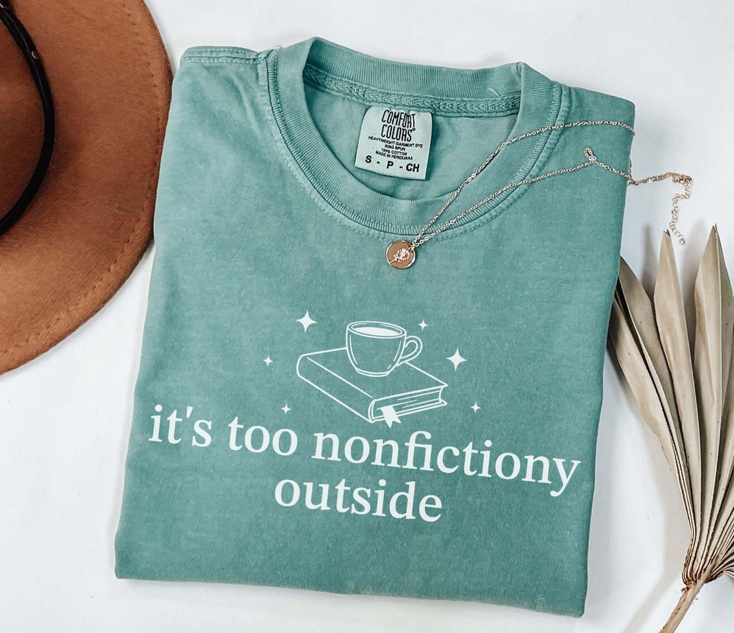 A comfort colors® shirt with the saying "it's too nonfictiony outside"