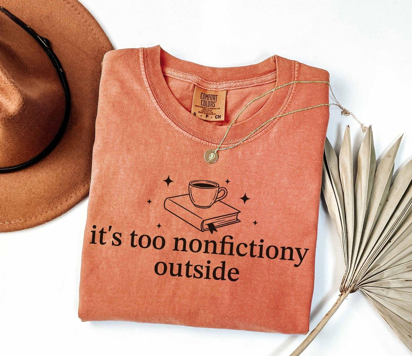 A comfort colors® shirt with the saying "it's too nonfictiony outside"