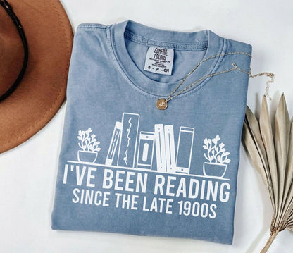 A comfort colors® shirt with the saying "i've been reading since the late 1900s"
