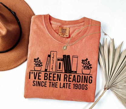 A comfort colors® shirt with the saying "i've been reading since the late 1900s"