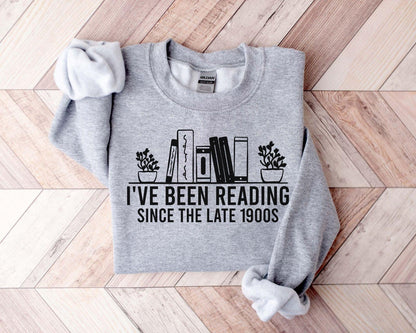 A Gildan 18000 sweatshirt with the saying "I've been reading since the late 1900s"